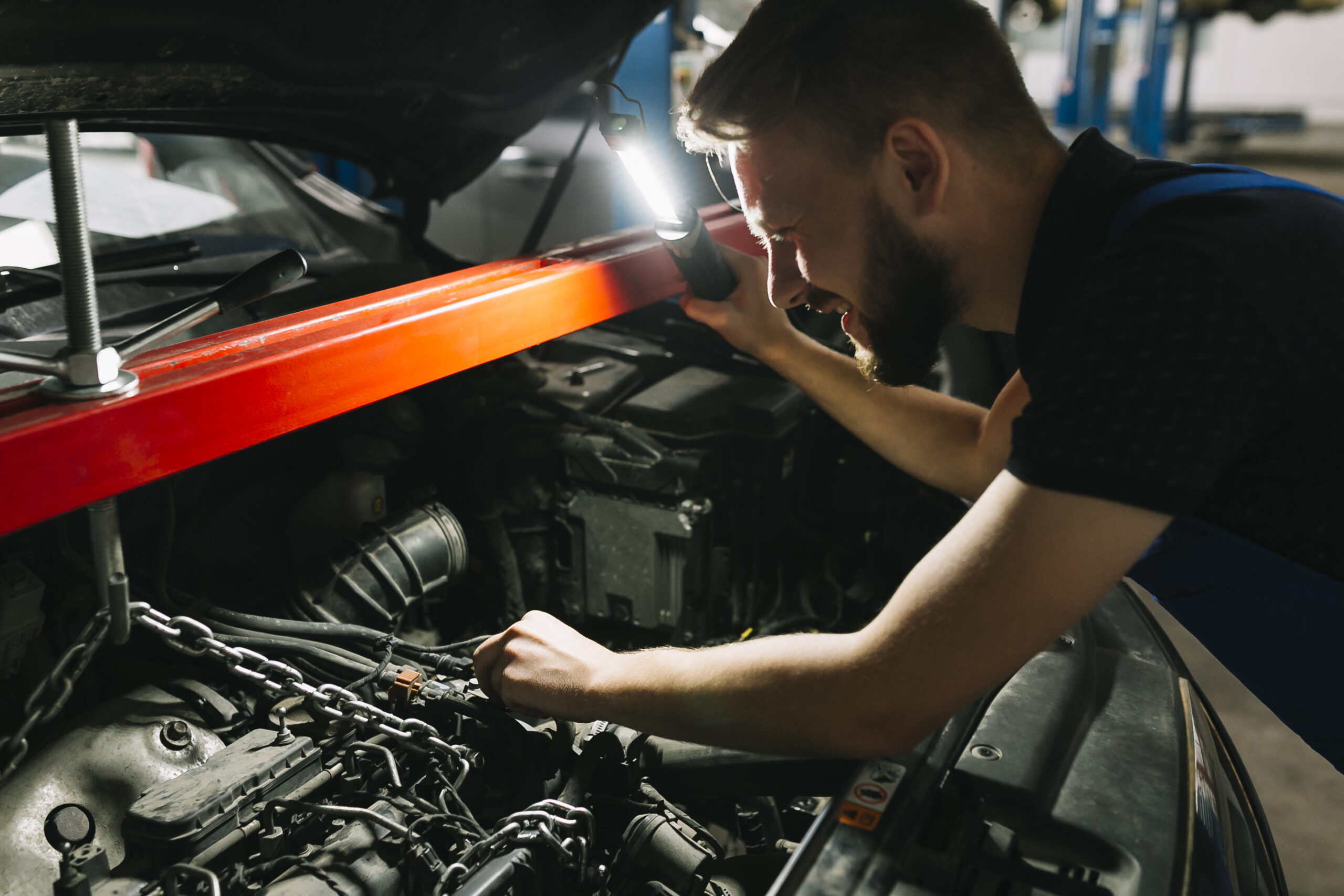 auto-mechanic-looking-car-s-engine