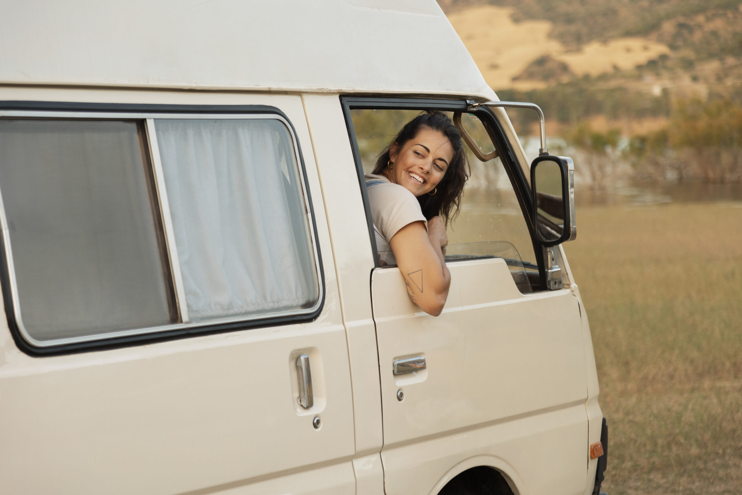 side-view-smiley-woman-campervan